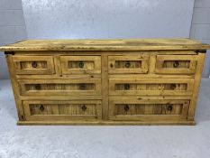 Mexican pine chunky modern sideboard with eight drawers and metal ring handles, approx 170cm x