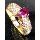 Foreign Gold ring set with a Red faceted stone possibly a Ceylon Ruby in a four clasp mount and with