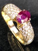 Foreign Gold ring set with a Red faceted stone possibly a Ceylon Ruby in a four clasp mount and with