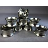 Good collection of six silver coloured heavy napkin rings by John Somers