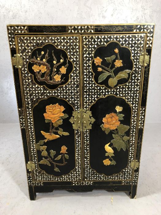 Oriental lacquered cabinet with with applied floral design, approx 60cm x 31cm x 90cm tall