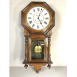 8 day spring-driven American wall clock by Waterbury Clock Co, English walnut case with floral inlay