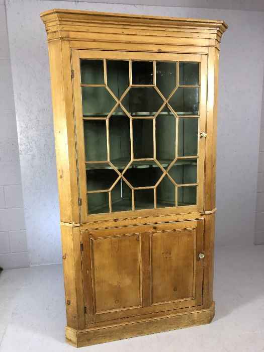 Large pine glazed corner unit with green painted interior and cupboard below, approx 105cm wide x