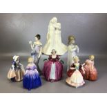 Collection of eight porcelain figurines to include a young girl playing a musical instrument by