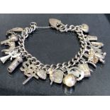 Silver Charm Bracelet with hallmarked silver heart shaped Lock and approx 18 silver and silver