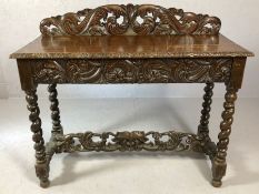 Heavily carved console table with carved drawer to front, carved stretcher and upstand on barley