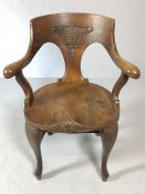 Substantial carved oak chair with saddle seat and turned H stretcher