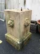 Cast garden plinth with lion head detailing, approx 55cm tall