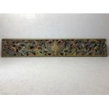 Decorative carved wooden panel with floral design and aged paint / patina in pale red, blue and