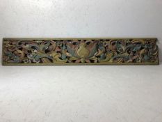 Decorative carved wooden panel with floral design and aged paint / patina in pale red, blue and