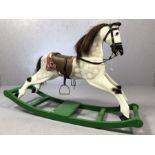 Vintage grey rocking horse with leather saddle on green rocker, approx 110cm x 70cm tall