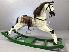 Vintage grey rocking horse with leather saddle on green rocker, approx 110cm x 70cm tall