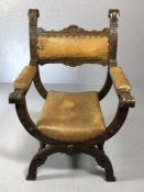 Heavily carved oak X-frame or Cross frame Gothic Revival chair with turned supports and leather pads