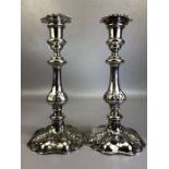 Pair of Silver coloured candle sticks approx 24cm tall