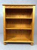 Pine bookcase on bun feet, approx 82cm x 32cm x 110cm tall