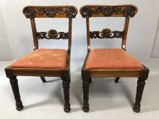 Pair of heavily carved antique chairs with fluted legs