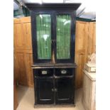 Vintage kitchen dresser with campaign-style handles to drawers and glazed cupboards over with