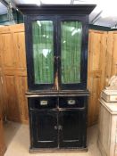 Vintage kitchen dresser with campaign-style handles to drawers and glazed cupboards over with