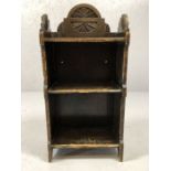 Small arts and crafts shelving unit with carved floral design, approx 75cm tall