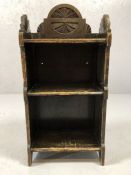 Small arts and crafts shelving unit with carved floral design, approx 75cm tall