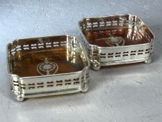 Pair of faux tortoiseshell and silver plated wine coasters