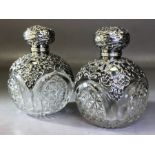 Pair of Victorian crystal Glass scent bottles with Hallmarked Silver scroll decoration & Silver