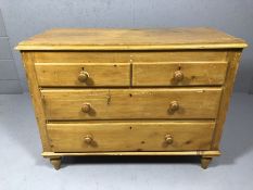 Pine chest of two long and two short drawers on raised turned feet, approx 105cm x 45cm x 80cm tall