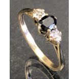 9ct Gold ring set with central faceted central stone and two illusion set diamonds to shoulders
