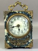 Small Bakelite marble effect carriage clock with gold gilt detailing and white circular face winds