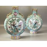 Pair of Chinese moon flask vases, each decorated to one side with figures and to the other side with