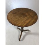 Antique circular tilt top table on three splayed legs on turned pedestal, approx diameter 55cm x