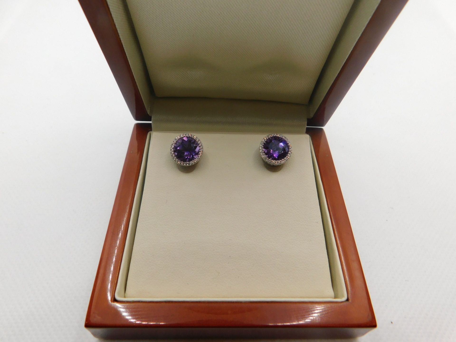 1 BOXED ROUND CUT PURPLE AMETHYST AND 0.18CTW DIAMOND EARRINGS RRP Â£499 (ONE HOLDING MISSING)