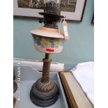 Paraffin lamp on circular brass and black pot base,