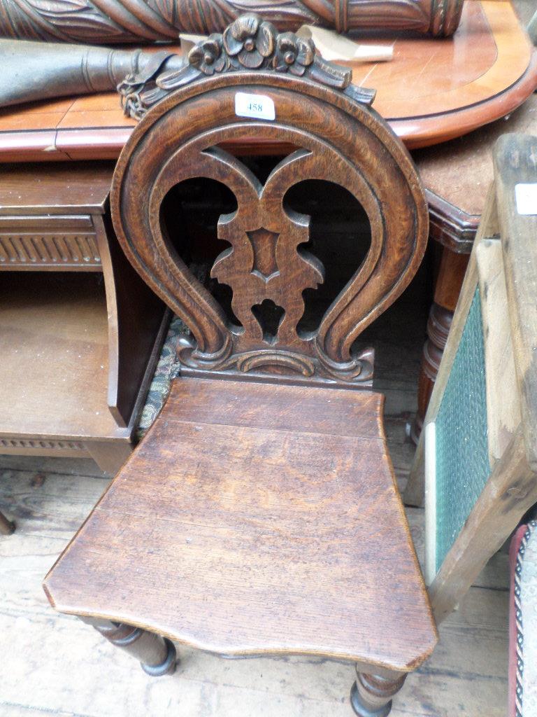 Carved oval backed hall chair on 4 tapering turned feet