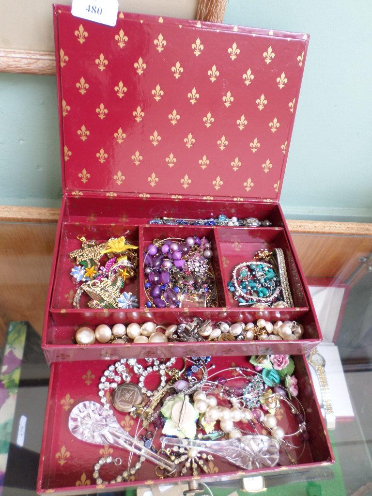 Maroon jewellery box containing a large sel.