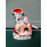 Decorative flatback Staffordshire vase on young girl seated over bridge with pair of swans on