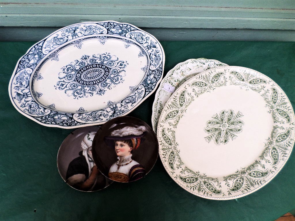 3 oval meat plates and a pair of wall plates each of a lady in traditional dress