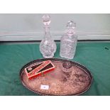Oval plated tray containing 2 cut glass spirit decanters,