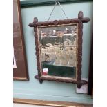 Small rectangular bevel edged mirror in decorative carved oak frame