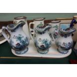 3 Decorative swan china graduated jugs and a further set of three graduated oriental patterned
