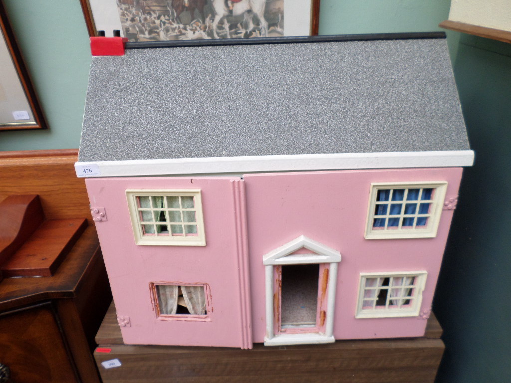 Pink walled dolls house with internal furniture
