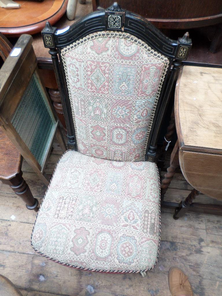Low high backed Victorian nursing chair on pot casters,