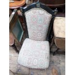 Low high backed Victorian nursing chair on pot casters,