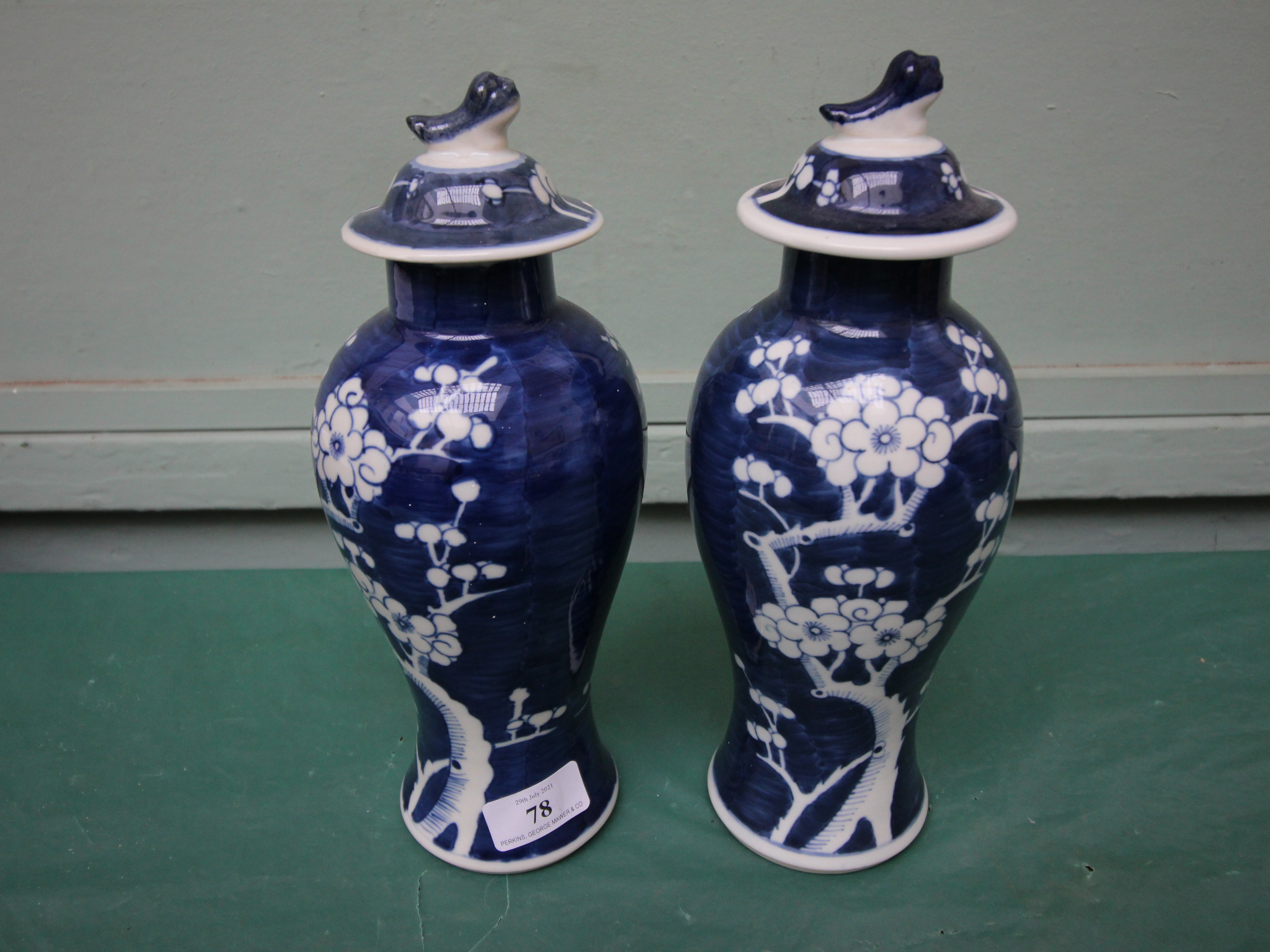 Pair of 20th century Chinese blue and white lidded vases (1 repaired)