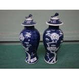 Pair of 20th century Chinese blue and white lidded vases (1 repaired)