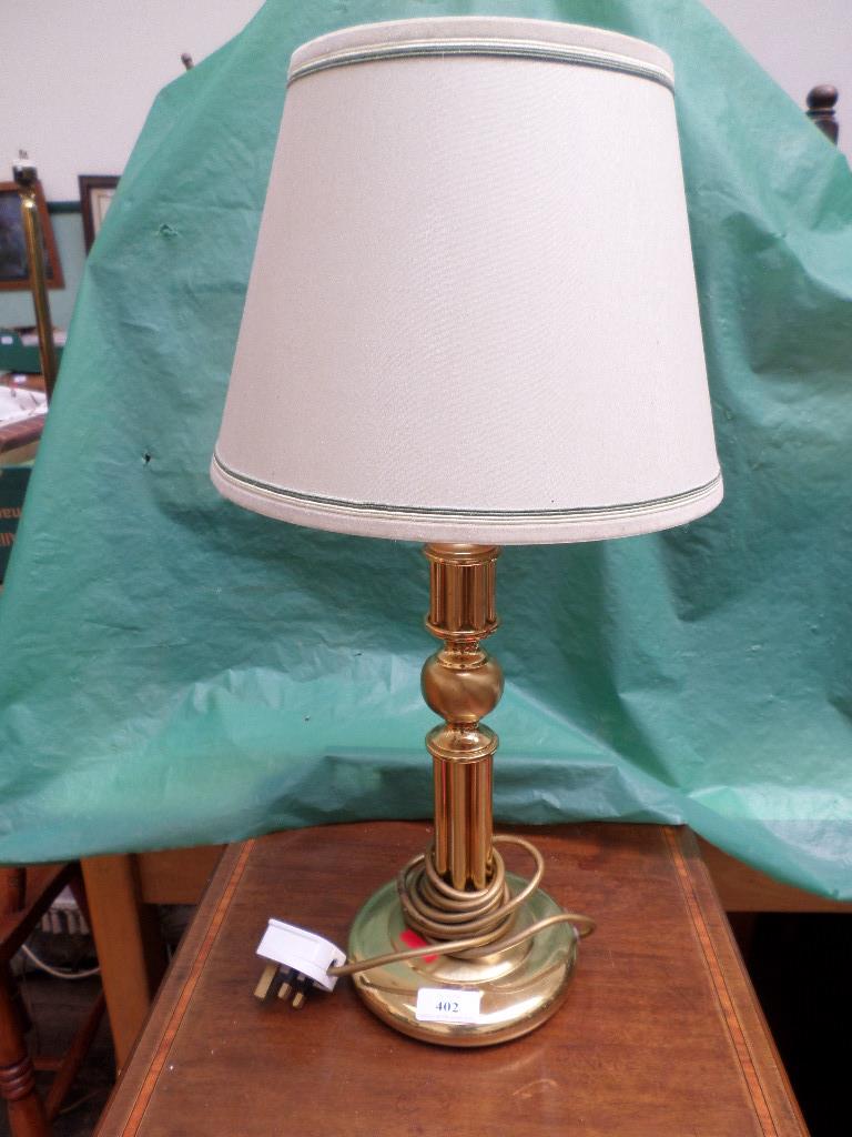 Brass table lamp with beige parchment shade