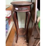 Carved circular topped plant stand with undershelf