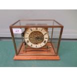 Unusual brass mantelclock with circular brass and light yellow enamel dial inset Roman Numerals all