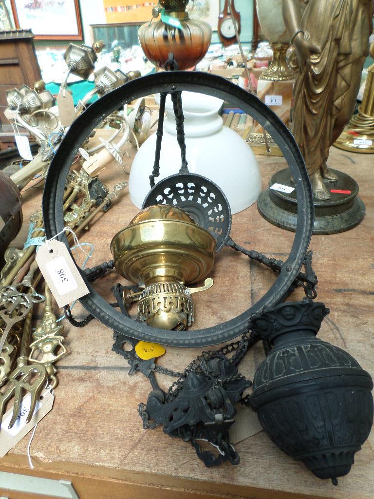 Brass ceiling light fitting with wrought iron surround and weight,