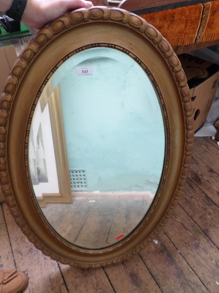 Oval gilt framed bevel edged mirror